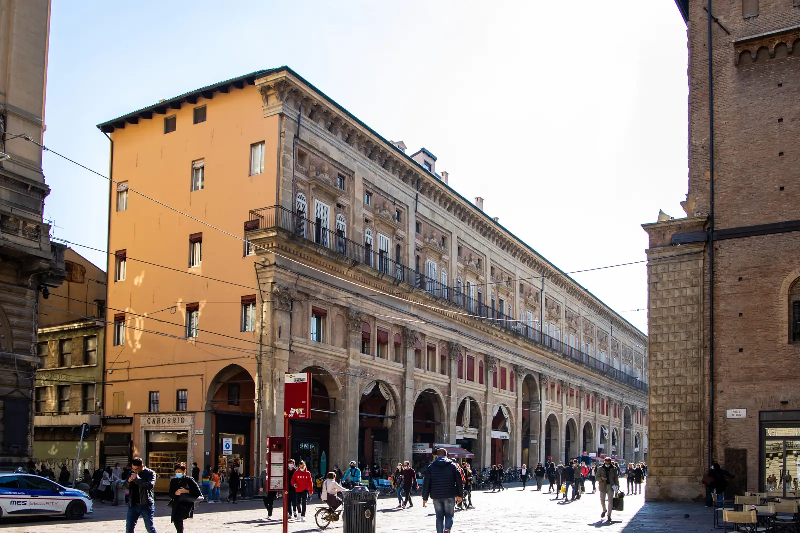 The arcade of Palazzo dei Banchi running along the east side of Piazza Maggiore