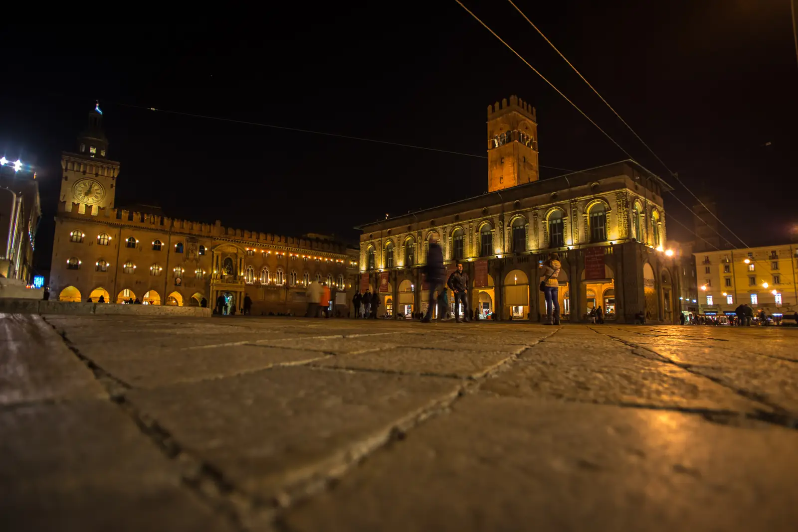 Piazza Maggiore in Bologna at night, with Palazzo d'Accursio and Palazzo del Podesta illuminated