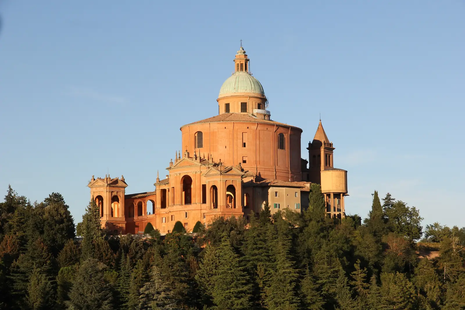 The Sanctuary of the Madonna di San Luca with its green copper dome, rising above the trees of Colle della Guardia