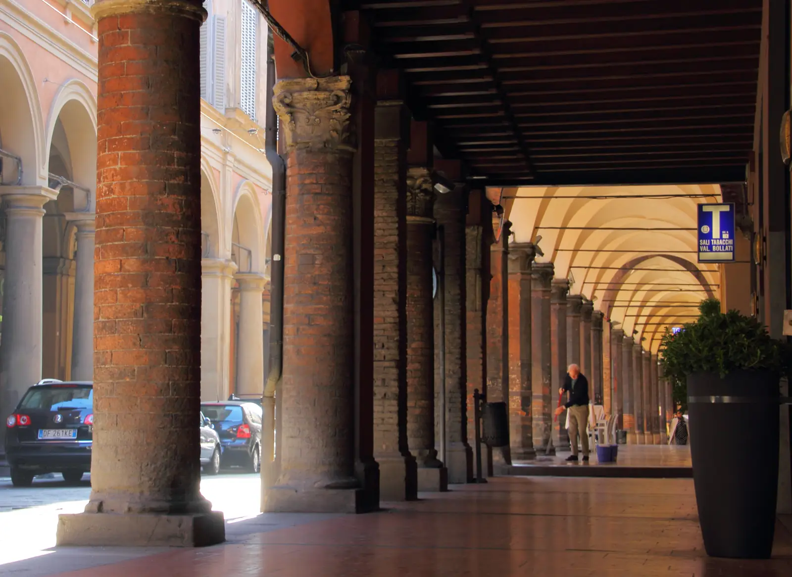 Brick columns and vaulted arches of the porticoes on Strada Maggiore in Bologna's historic center